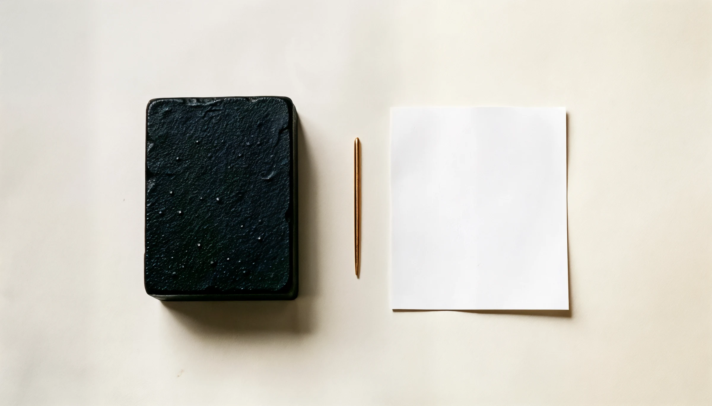 A cast-iron block beside a single sheet of paper